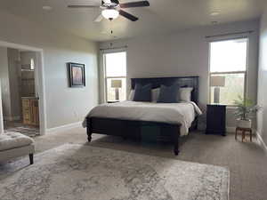 Carpeted bedroom featuring recessed lighting, ensuite bath, and ceiling fan