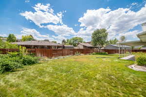 Fenced backyard with a residential view and a patio
