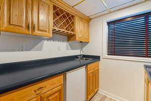 Kitchen featuring dark countertops, refrigerator, and a paneled ceiling