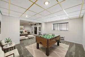 Rec room with a paneled ceiling, carpet, and recessed lighting