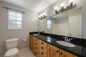 Bathroom featuring double vanity and a shower