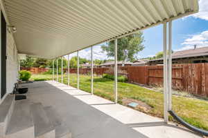 Fenced backyard with a patio area