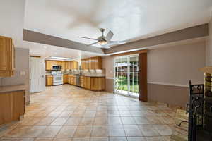 Kitchen with ceiling fan, light tile patterned floors, stainless steel appliances, tasteful backsplash, and recessed lighting