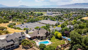 Aerial view of residential area featuring a mountain backdrop and a pool
