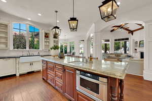 Kitchen featuring crown molding, ornate columns, a ceiling fan, healthy amount of natural light, and recessed lighting
