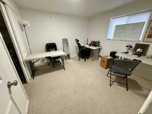 Office space featuring light carpet and baseboards