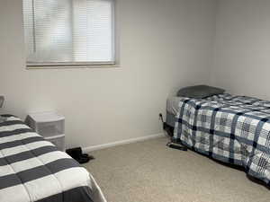 Carpeted bedroom featuring baseboards