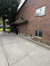 View of Triplex exterior with brick siding