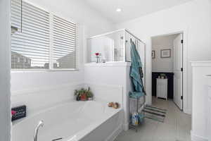 Bathroom with a garden tub and a shower stall