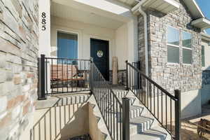 Doorway to property featuring stone siding