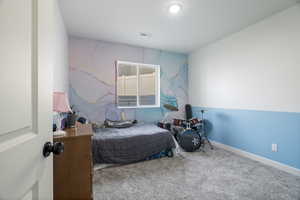 Carpeted bedroom featuring baseboards