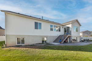 Rear view of house featuring a patio area and stairs