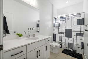 Bathroom featuring vanity and curtained shower