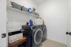 Laundry room featuring independent washer and dryer and baseboards