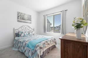 Carpeted bedroom with baseboards