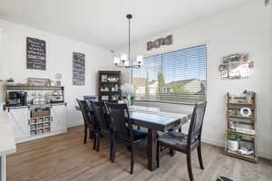Dining space featuring a chandelier and light wood-type flooring