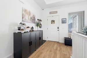 Foyer featuring light wood-style flooring and baseboards