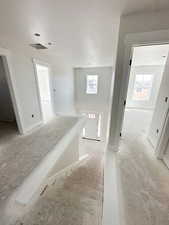 Hall with an upstairs landing and a textured ceiling