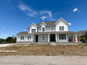 Modern farmhouse exterior with light gray siding and white trim