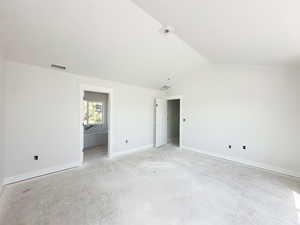 Unfurnished bedroom with baseboards and vaulted ceiling