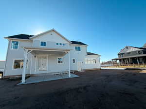 Back of house featuring a porch and board and batten siding