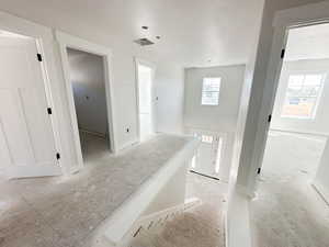 Stairway featuring a textured ceiling