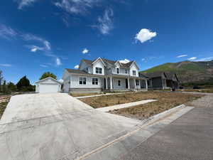 Two-story residence featuring light gray siding, white trim, and a stone-clad foundation