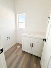 Bathroom with vanity and dark wood-style floors