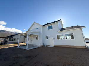 Rear view of property featuring a patio area and board and batten siding