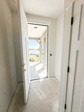 Doorway featuring unfinished concrete floors