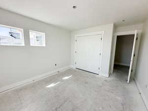 Unfurnished bedroom with a closet and baseboards