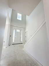 Foyer featuring a towering ceiling