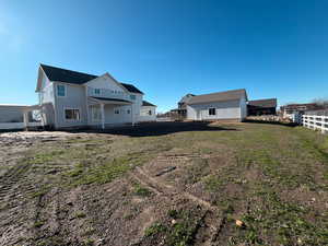 Back of property featuring board and batten siding and a patio area