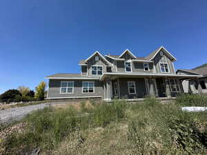 Craftsman inspired home with a porch and a shingled roof