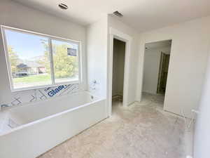 Bathroom featuring a bath and a mountain view