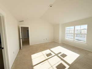 Empty room with baseboards and lofted ceiling