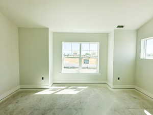 Empty room featuring plenty of natural light