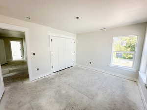 Unfurnished bedroom with a closet and a textured ceiling