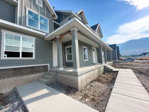View of home's exterior featuring covered porch and a mountain view