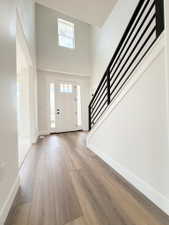 Two-story foyer featuring a prominent staircase with a contemporary horizontal railing