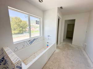 Full bath with a bath and a mountain view