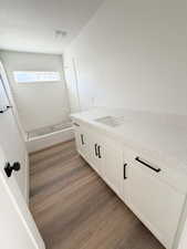 Full bathroom featuring vanity, dark wood-style flooring, and shower / bathtub combination
