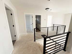 Corridor featuring an upstairs landing