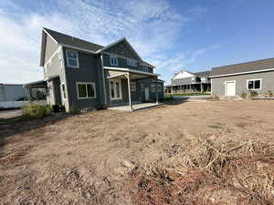 Rear view of property with a patio and board and batten siding