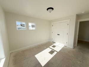 Unfurnished bedroom featuring a closet and baseboards