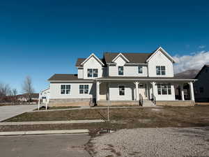 Modern inspired farmhouse featuring a porch, roof with shingles, and board and batten siding