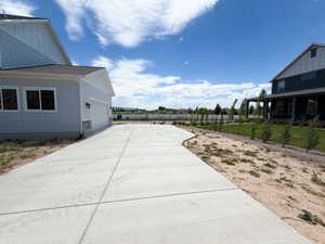 Expansive concrete driveway with a gently curving walkway
