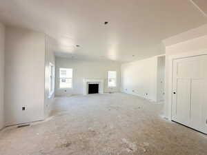 Unfurnished living room featuring a fireplace
