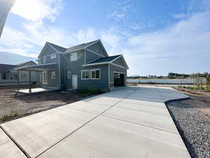 View of front of home with board and batten siding and a shingled roof
