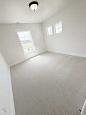Room featuring light-toned patterned carpeting and white walls